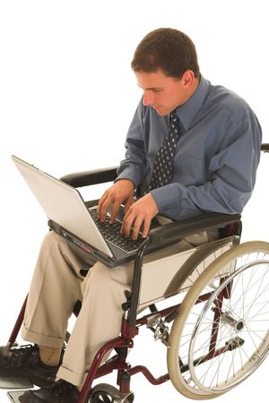 Businessman working on a laptop in a wheelchairの写真素材