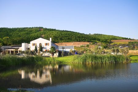 The Fairview wine farm in South Africa, overlooking a large reservoir dam. The Paarl, Afrikaans Language monument is just visible in on the horizonの写真素材