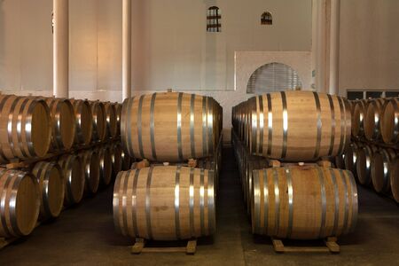 Stacked Oak barrels for maturing red wine and brandy in a cooling cellar. Made from American and Canadian oak and stacked in rows. (low noise HDR file  no noise reduction filters/software used)の写真素材