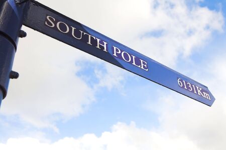 A blue distance marker against a cloudy blue sky for the South Pole (in km)の写真素材
