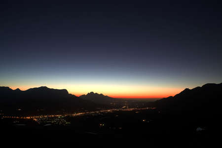 Sunset over the small town of Franschhoek and nearby wine farms. Feint star trails in the sky right after sunsetの写真素材