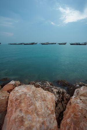 Fishing dhows at the harbour of the old pearling town of Al Wakrah in Qatar, Middle East, right before sunrise (movement on the Dhows)の写真素材