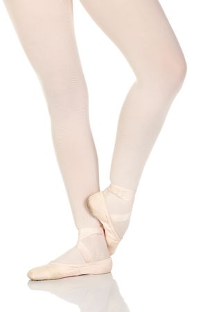 Young caucasian ballerina girl on white background and reflective white floor showing various ballet steps and positions. Not Isolatedの写真素材