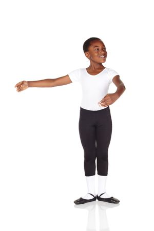 Young African ballet boy on white background and reflective white floor showing various ballet steps and positions. Not Isolatedの写真素材