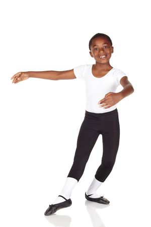 Young African ballet boy on white background and reflective white floor showing various ballet steps and positions. Not Isolatedの写真素材