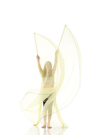Young Caucasian belly dancing girl in beautiful decorated clothes on white background and reflective floor. Not isolatedの写真素材