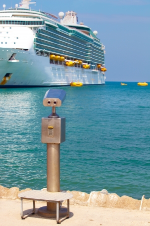 A metallic coin operated viewer for tourists to look at the white holiday cruise liners in the port of Kusadasi, Turkey, on the Aegean Coastの写真素材