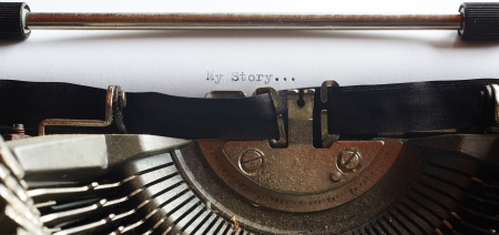 A Closeup image of the typebars and ribbon of an old style typewriter and paper with the text  My Story     Shallow Depth of Field  in a panorama cropの写真素材