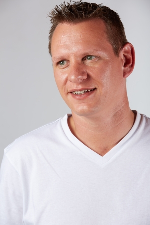 Portrait of a casually dressed young adult caucasian man against a neutral background の写真素材