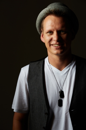 Portrait of a casually dressed young adult caucasian man against a neutral background.の写真素材