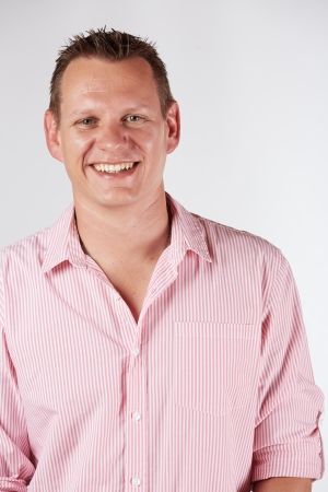 Portrait of a casually dressed young adult caucasian man against a neutral background.の写真素材