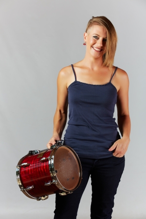 Beautiful young adult blonde caucasian woman with an funky modern hair cut on a neutral backgroundの写真素材