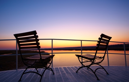 Colourful sunrise from the deck of a riverboat on the Chobe river between Botswana and Namibia in Southern Africaの写真素材