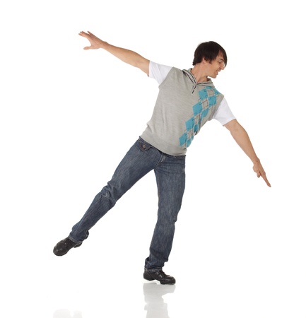 Tap dancer in blue jeans and tap shoes doing steps on a white background and floorの写真素材