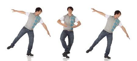 Tap dancer in blue jeans and tap shoes doing a combination of steps on a white background and floorの写真素材
