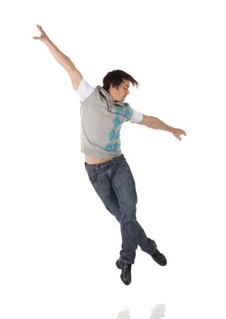 Tap dancer in blue jeans and tap shoes doing steps on a white background and floorの写真素材