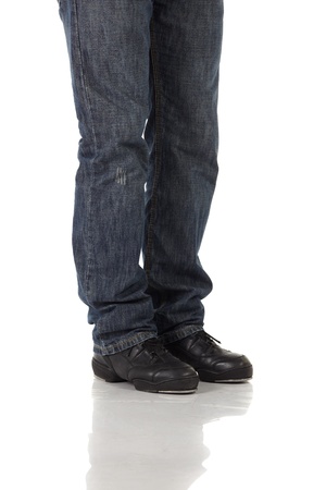 Single male tap dancer wearing jeans showing various steps in studio with white background and reflective floor  Not isolated の写真素材