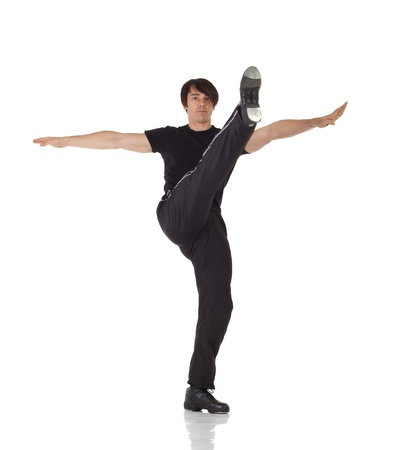 Tap dancer in blue jeans and tap shoes doing steps on a white background and floorの写真素材