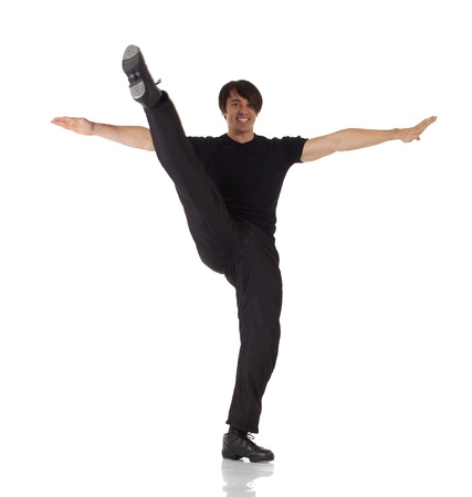 Tap dancer in blue jeans and tap shoes doing steps on a white background and floorの写真素材