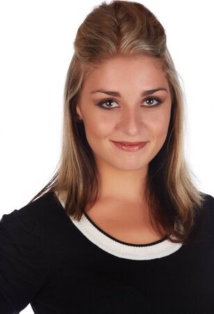 Beautiful and sexy young adult caucasian businesswoman with honey blonde hair wearing a casual white and black business outfit against a white backgroundの写真素材