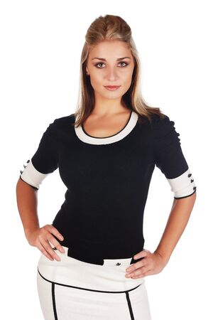 Beautiful and sexy young adult caucasian businesswoman with honey blonde hair wearing a casual white and black business outfit against a white backgroundの写真素材