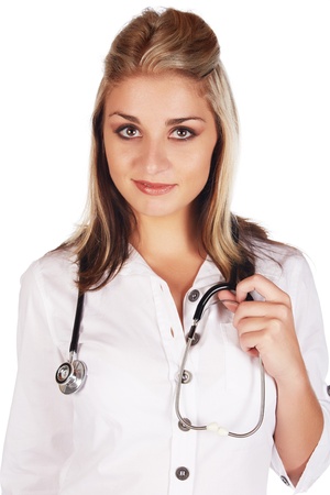 Beautiful young adult caucasian medical doctor with honey blonde hair wearing a casual white outfit and with a stethoscope in her hands against a white backgroundの写真素材