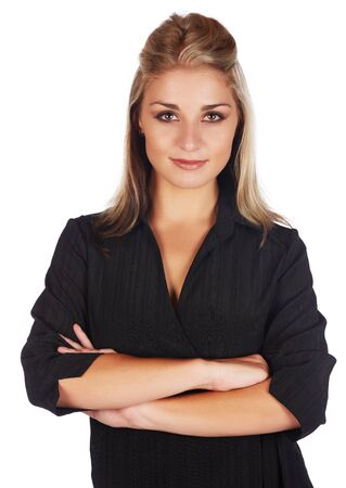 Beautiful and sexy young adult caucasian businesswoman with honey blonde hair wearing a casual black business outfit against a white background and with her arms crossedの写真素材