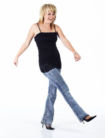 Beautiful young blonde caucasian woman in a black top against a white backgroundの写真素材