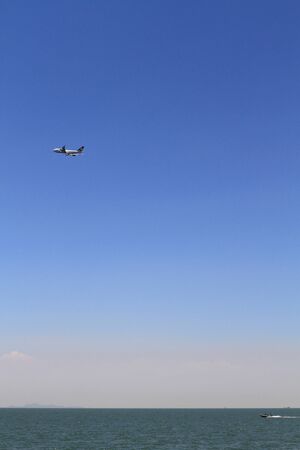 Jet airplane over oceanの写真素材