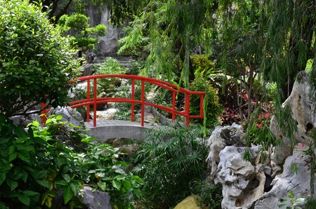 Chinese Water Garden Bridge and Reflection Amid Modern High の写真素材