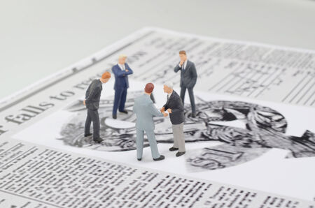 a small figures and newspaperの写真素材