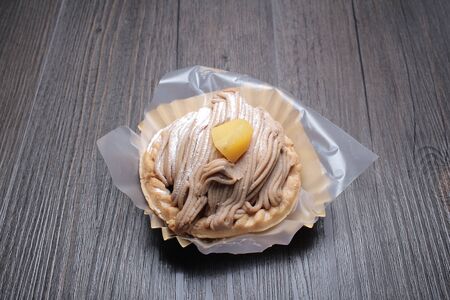 a Small chestnut cake with wood background