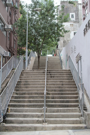 Narrow walking street with long staircase at hkのeditorial素材