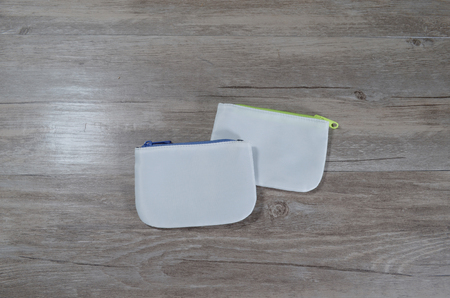a coins bag with white area on wood background