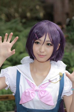 Girls dressed as anime characters pose at a cosplay gathering.
