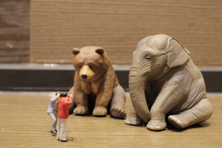 a plastic animal toy with figure peopleの写真素材