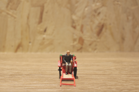 the Miniature statue  and red vintage oriental rickshaw cabの写真素材