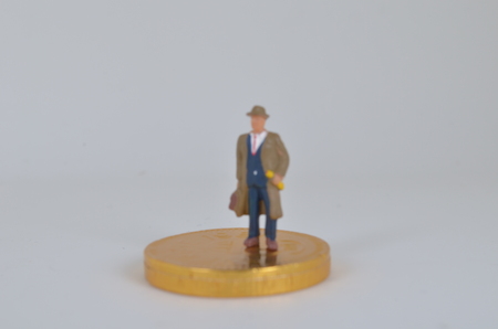 the Businessman on the top of coins stackの写真素材