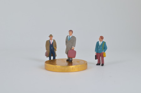 the Businessman on the top of coins stackの写真素材