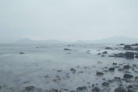 Rocks on the Sea coast at cloud dayの写真素材