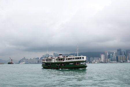famous ferry on Victoria harbor in Hong Kong with tall buildings 2016のeditorial素材