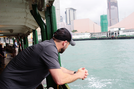 man at sea scape on a ferry boat from back viewの写真素材