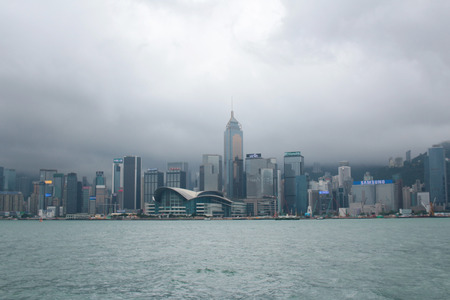 Victoria Harbor with city skyline and cloud in the day.