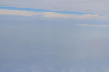 a view from the window of an airplane flying in the cloudsのeditorial素材
