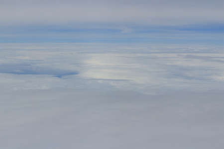 a view from the window of an airplane flying in the cloudsのeditorial素材