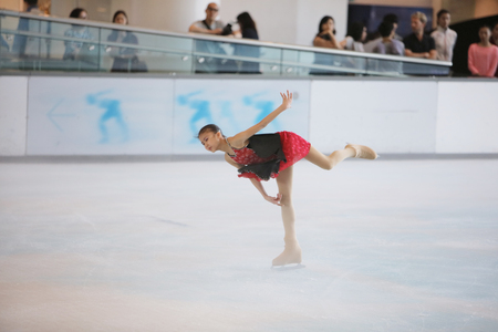 the  young skater performs on the iceのeditorial素材