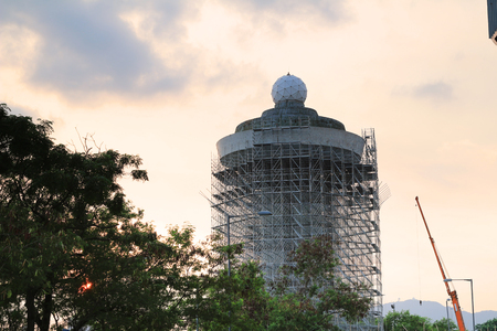 building and cranes under construction at sunsetの写真素材