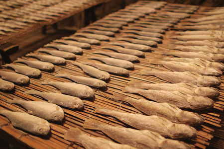 Salty dry river fish on a wooden impressive background.の写真素材