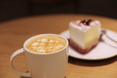 the Cup of latte coffee with cakeの写真素材