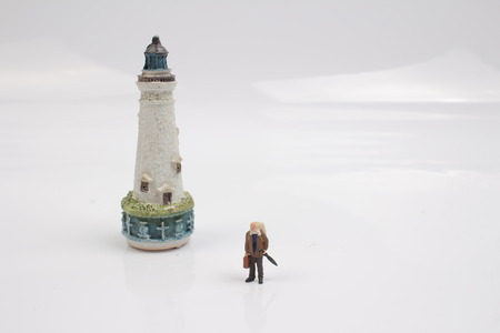 Miniature people traveler concept with lighthouseの写真素材